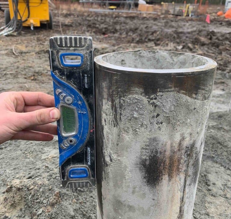 Checking pile plumb before grout on a foundation job