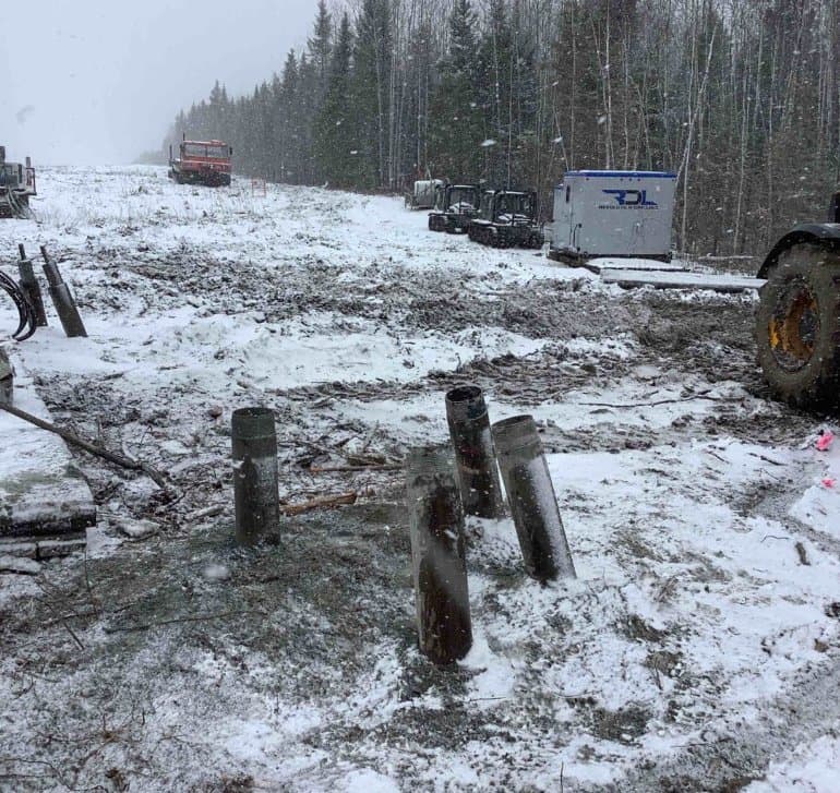 Foundation piles staged before grout on a northern site