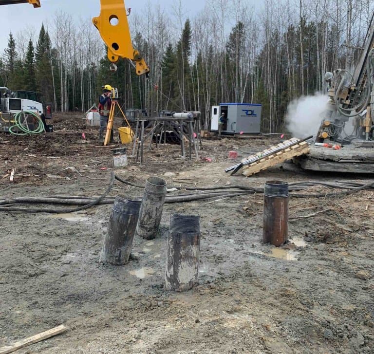 Foundation drilling and piles before grout on an active pad