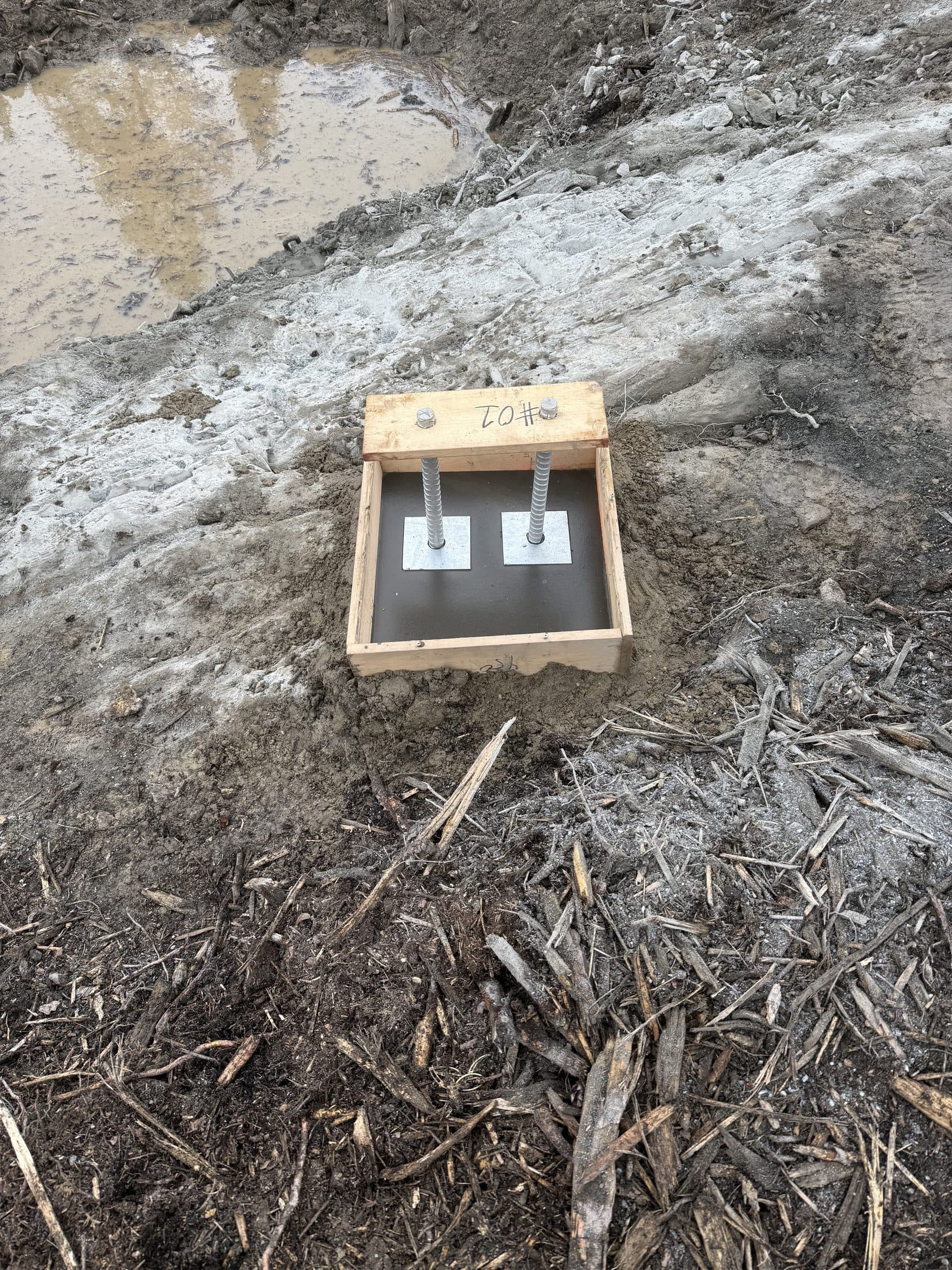 Finished guy-anchor plate and grout pad from the field