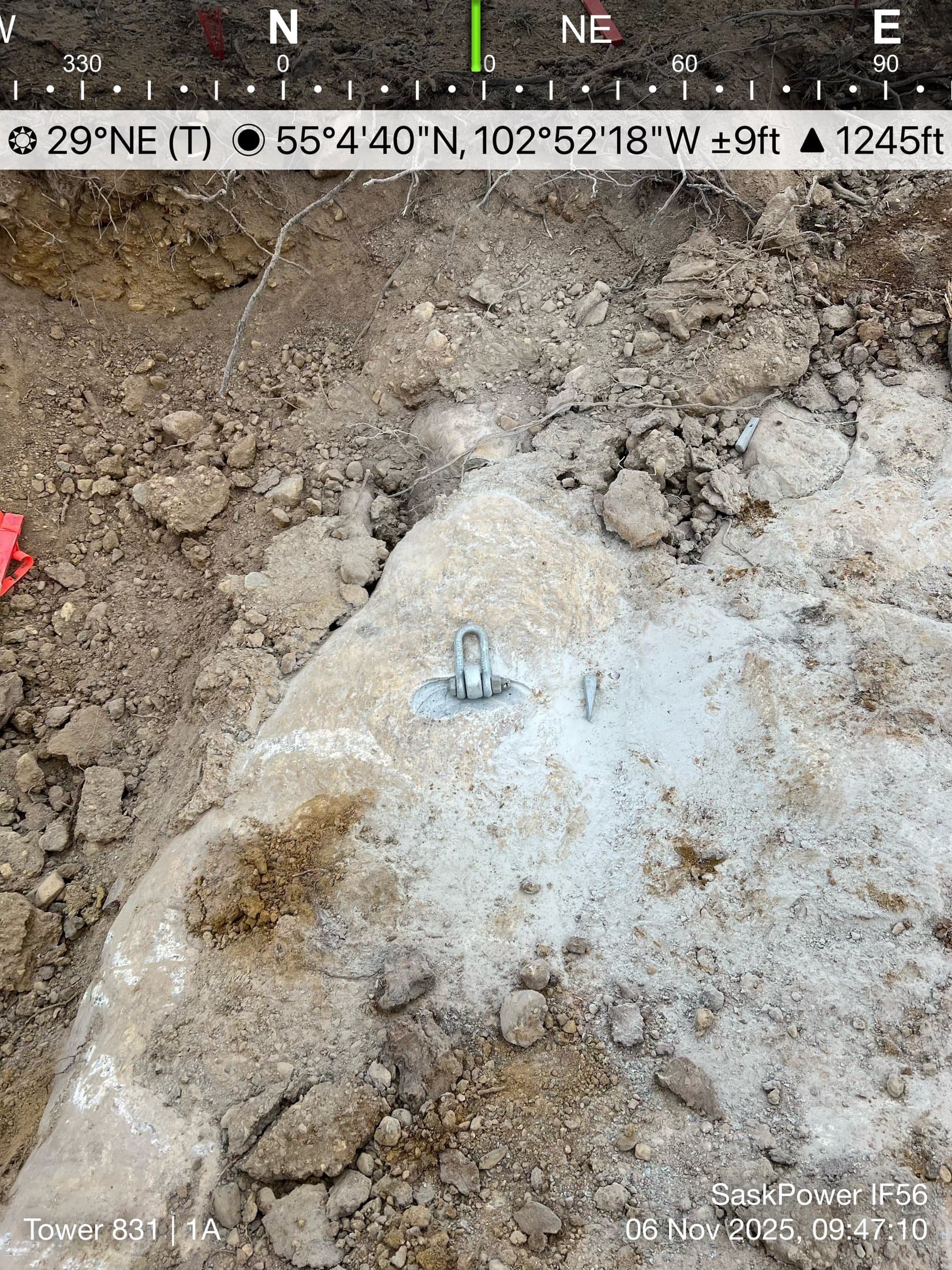 Rock-anchor shackle grouted into bedrock on a tower site