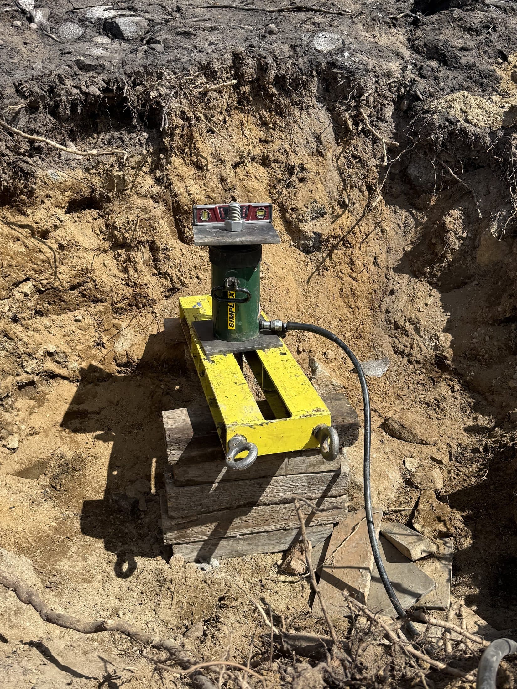 Crew performing foundation-anchor stress testing